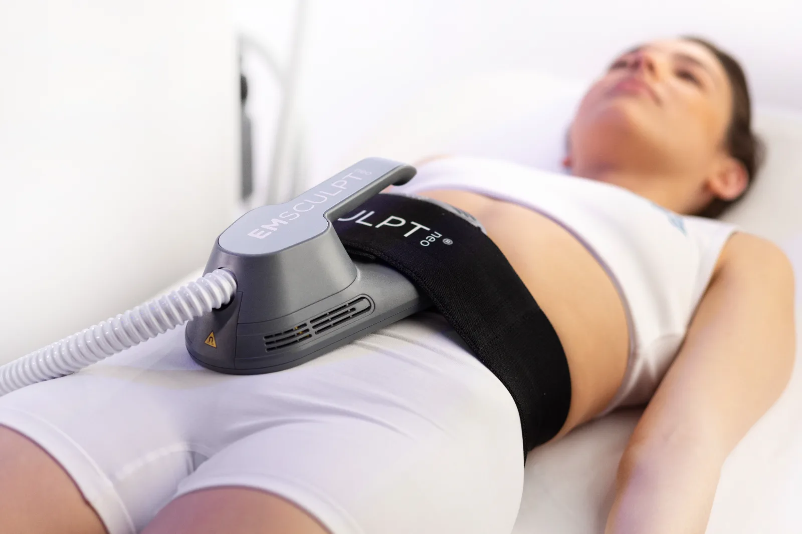 EMSculpt Neo applicator on a patient’s abdomen