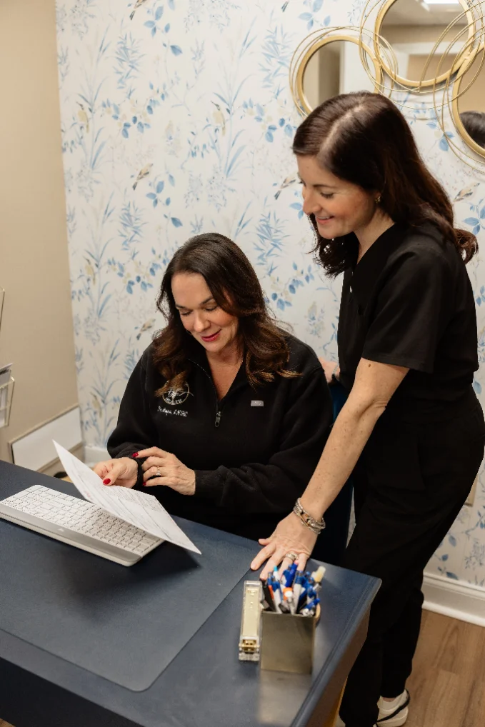 Nurse practitioner talking with a patient about perimenopause symptoms