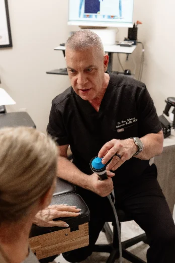 Dr. Ron Federico treating a patient’s hand